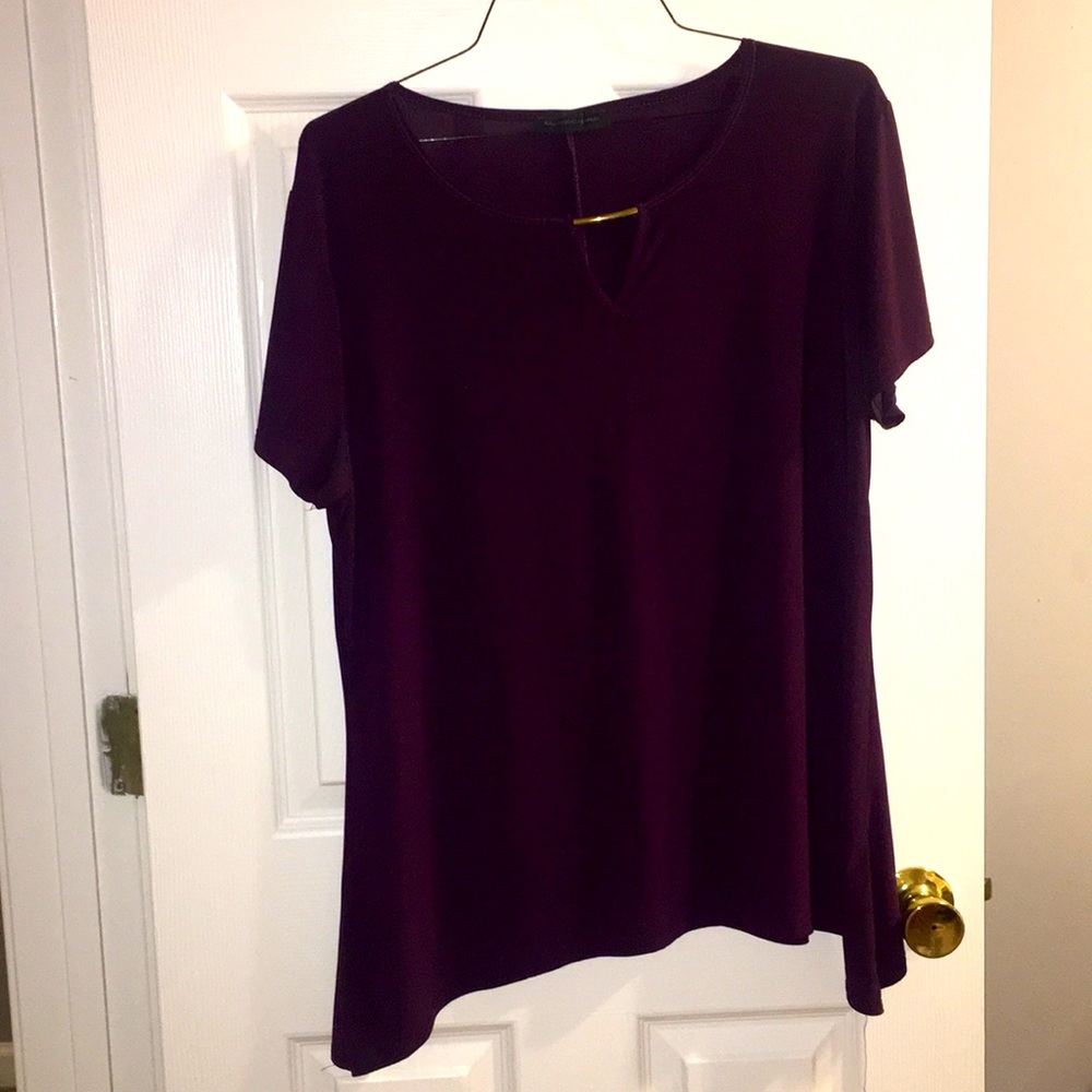 Purple blouse with gold bar detail.